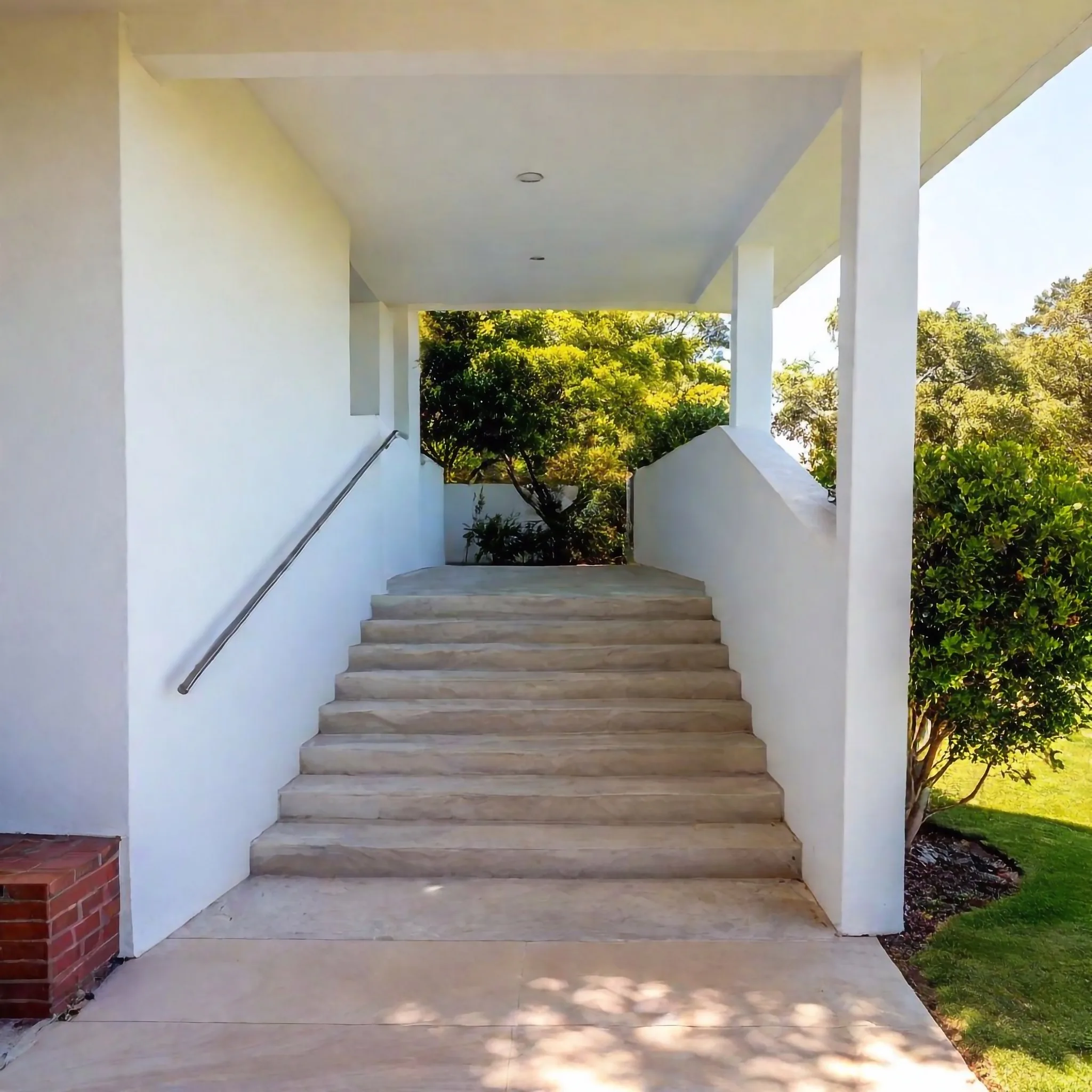 Concrete steps leading up to a covered entry